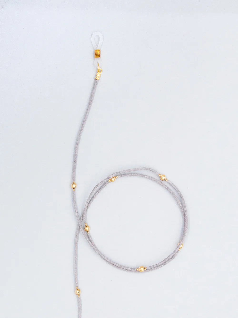 Brillenband grau aus gewachster Baumwollkordel in 1,5 mm Dicke mit goldenen Perlen und Gummihalterung auf weissem Hintergrund