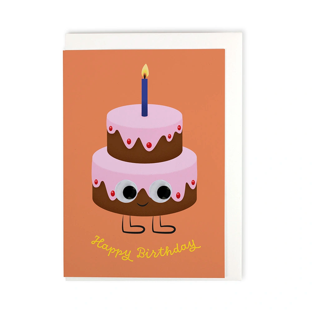 Aufsicht auf eine Faltkarten mit einer illustrierten Geburstags und dem Schriftzug "Happy Birthday" inklusive Couvert. orte